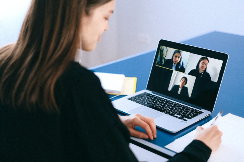 woman working remotely attending video meeting